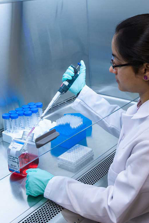 a lab worker beakers, dabbers and other biology lab tools
