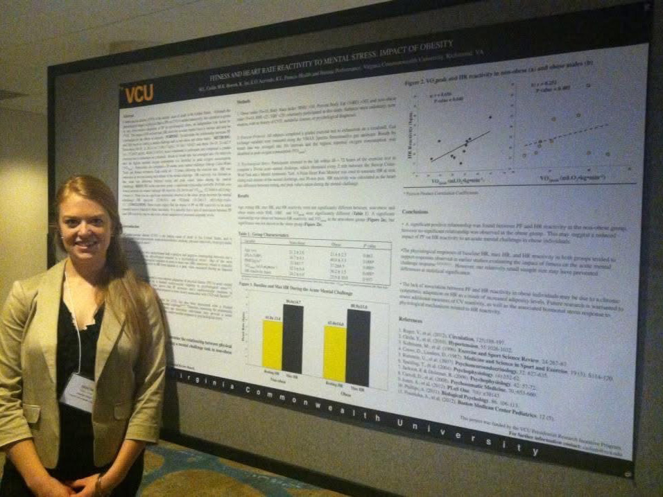 Heather Caslin stands in front of a research poster