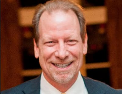 Picture of Dr. Rob Tombes smiling in a suit