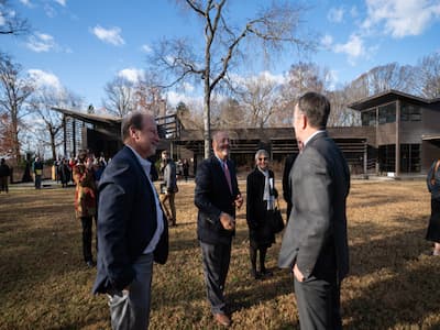 Dr. Rob Tombes standing with Dr. Greg Garman and Virginia Governor Ralph Northam at the Rice Rivers Center