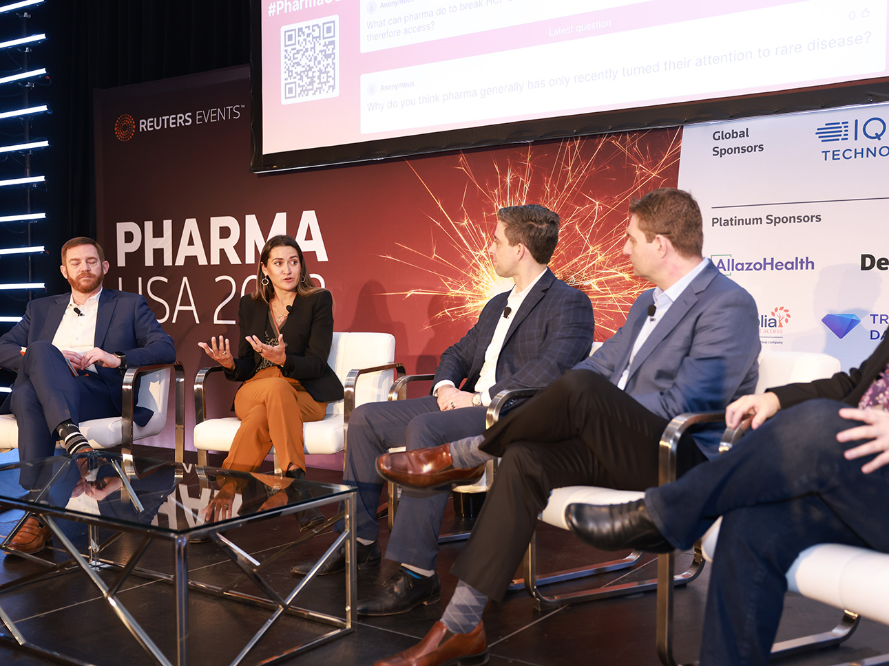 Ella Balasa sits on stage having a conversation with other panel members